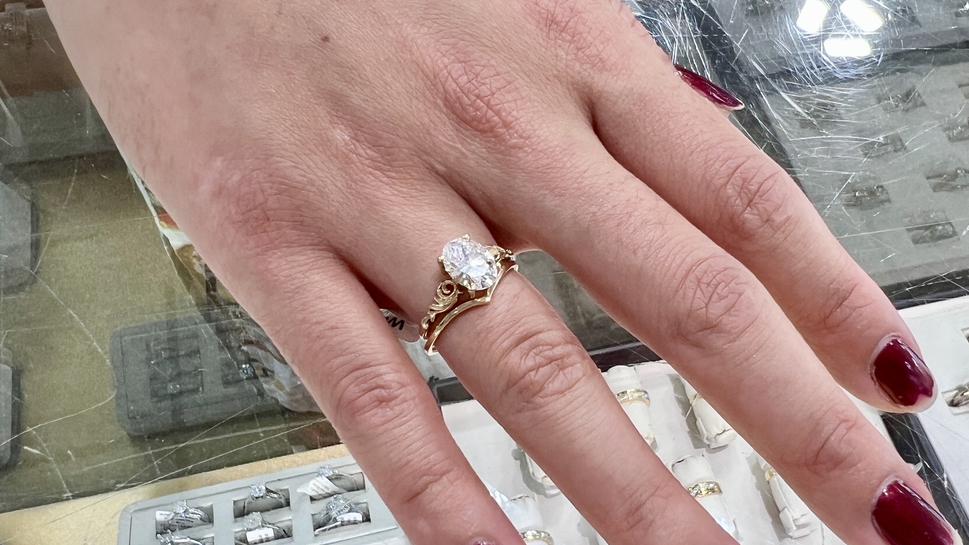 lab diamond oval engagement ring with chevron band on models hand